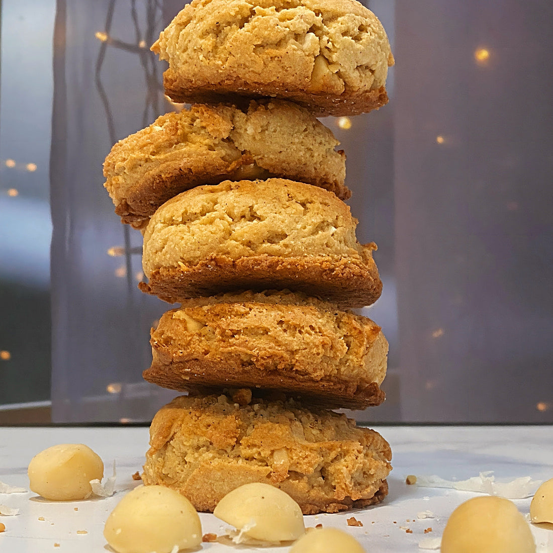 five Taste of the Island Cookies stacked ontop each other [macadamia nuts|white chocolate|coconut]